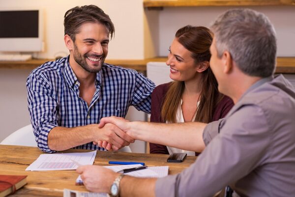 Couple shaking hand to financial agent Couple shaking hand to financial agent