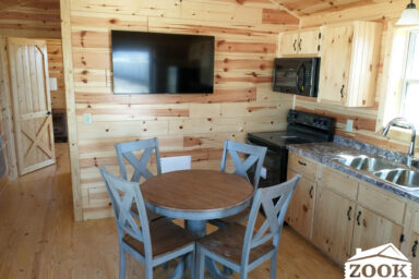 hunting cabin with a kitchen and living area