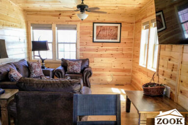 small cabin living area with a television